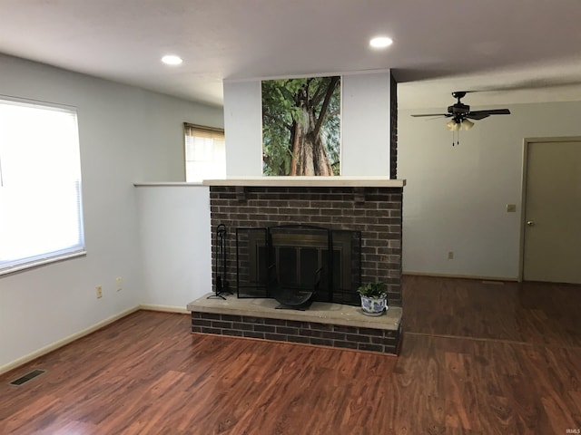 unfurnished living room featuring recessed lighting, visible vents, a brick fireplace, wood finished floors, and baseboards