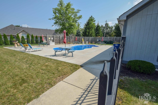 community pool featuring a patio area, a yard, and a fenced backyard