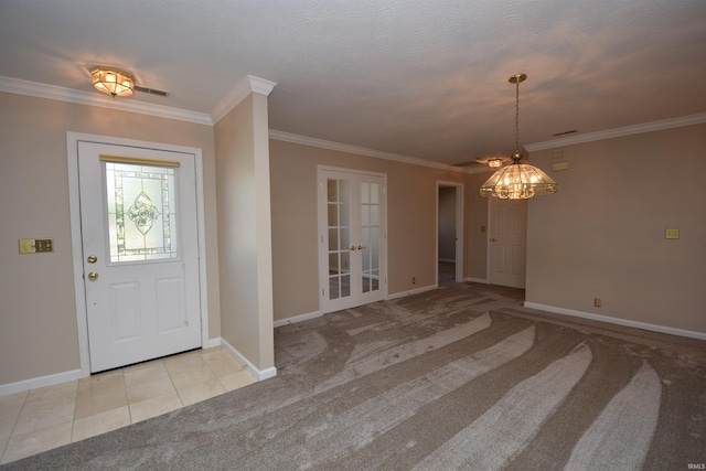 entrance foyer with light carpet, light tile patterned floors, baseboards, and crown molding