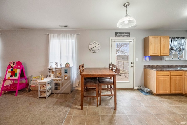 dining room with baseboards and light tile patterned flooring