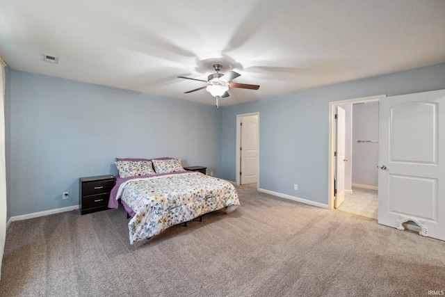 carpeted bedroom with a ceiling fan, visible vents, and baseboards