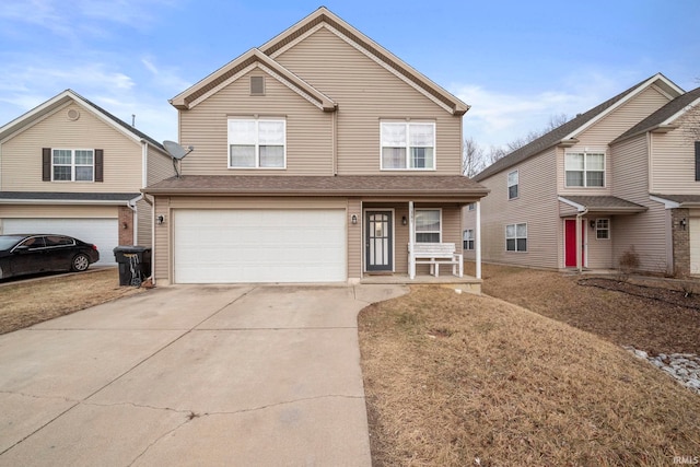 traditional home featuring an attached garage, covered porch, and concrete driveway