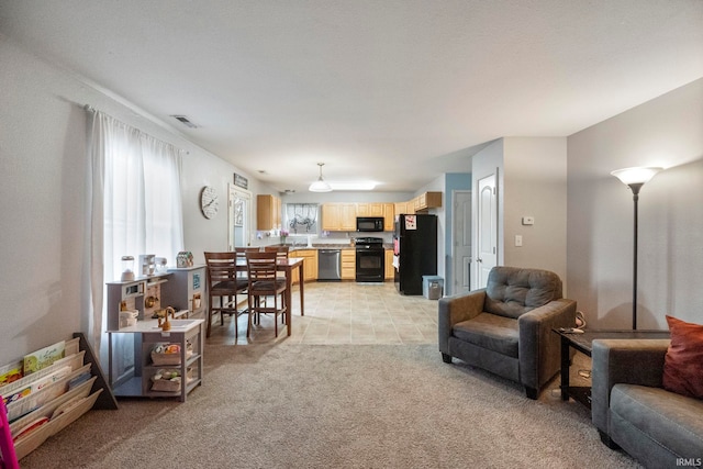 living room with light carpet and visible vents