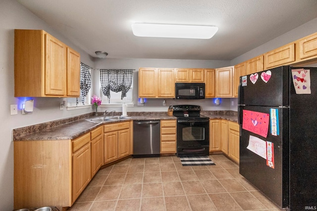 kitchen with light tile patterned floors, light brown cabinets, a sink, black appliances, and dark countertops