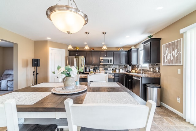 dining room featuring baseboards and recessed lighting