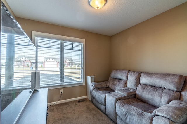 living room featuring carpet flooring, visible vents, and baseboards