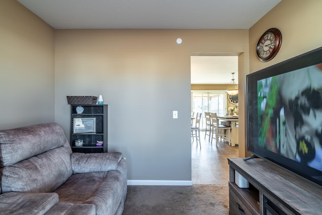 carpeted living room featuring baseboards