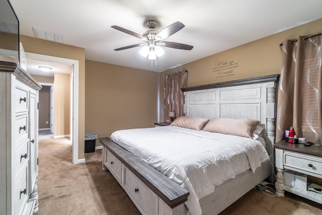 bedroom featuring baseboards, visible vents, a ceiling fan, and light colored carpet