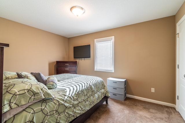 carpeted bedroom featuring baseboards