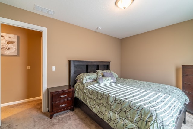 bedroom with light carpet, visible vents, and baseboards