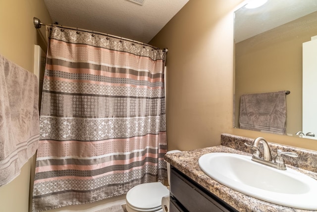 full bath featuring toilet, a shower with shower curtain, a textured ceiling, and vanity