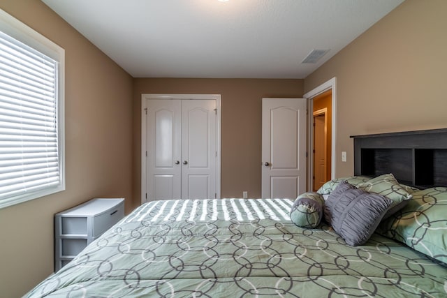 bedroom with visible vents and a closet