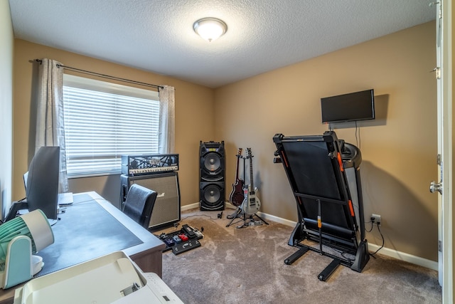 home office with a textured ceiling, carpet, and baseboards