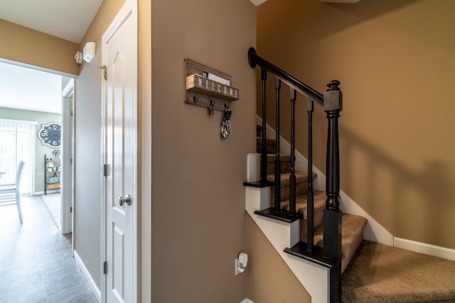 stairway featuring baseboards