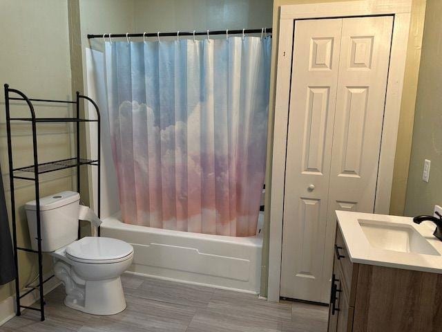 bathroom with vanity, toilet, and shower / tub combo with curtain