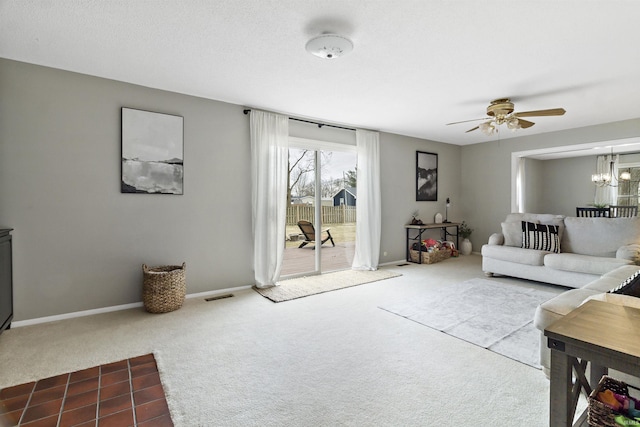 carpeted living room with ceiling fan with notable chandelier, a textured ceiling, visible vents, and baseboards