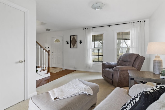 living area with stairway and baseboards