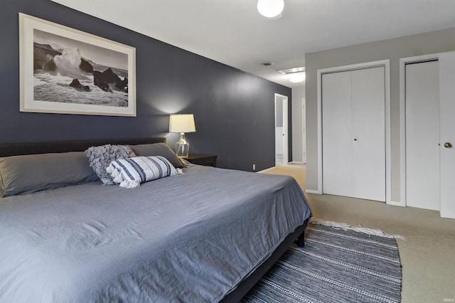 carpeted bedroom with multiple closets