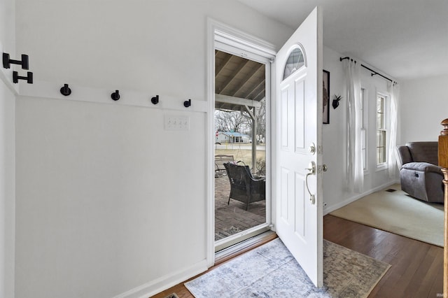 interior space with wood-type flooring and baseboards