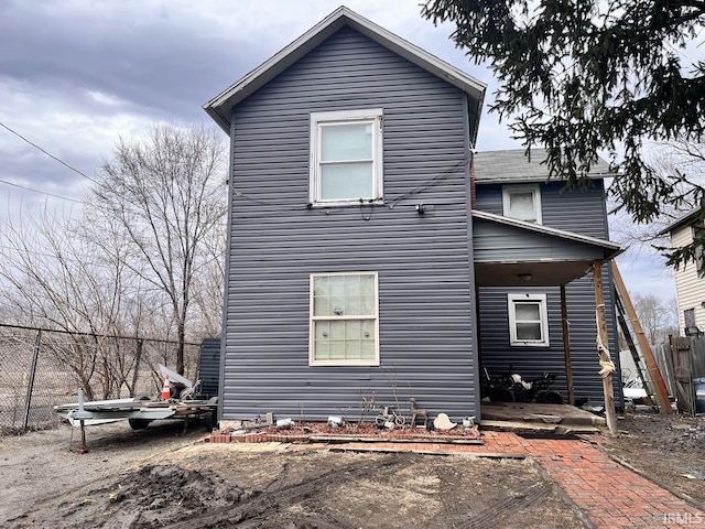 rear view of property with fence