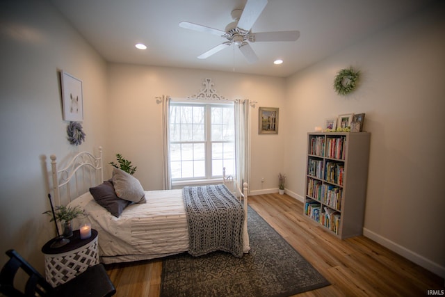 bedroom with a ceiling fan, baseboards, wood finished floors, and recessed lighting