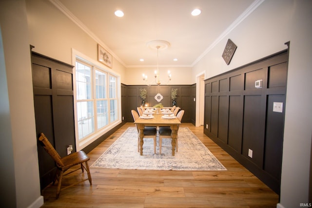 unfurnished dining area with light wood-type flooring, recessed lighting, a chandelier, and ornamental molding