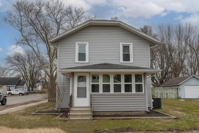 view of front of property with entry steps, a front yard, central AC, fence, and an outdoor structure