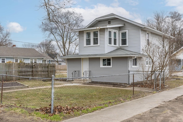 traditional style home with a front yard and fence