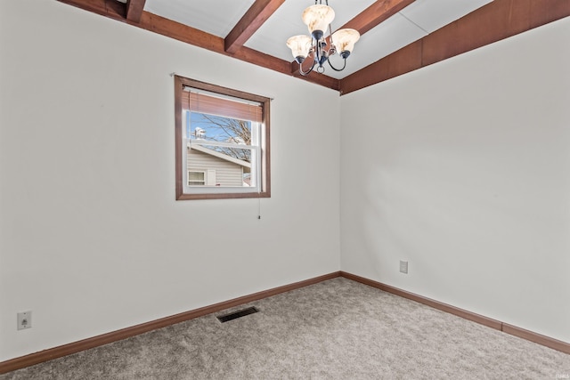 carpeted empty room with baseboards, visible vents, a chandelier, and beam ceiling