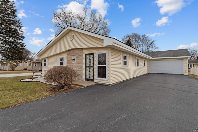 view of side of property featuring a garage and a yard