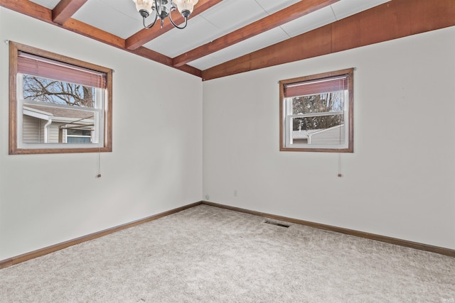 unfurnished room featuring lofted ceiling with beams, carpet floors, visible vents, baseboards, and an inviting chandelier