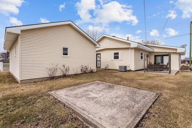 back of house featuring a patio, a lawn, and cooling unit