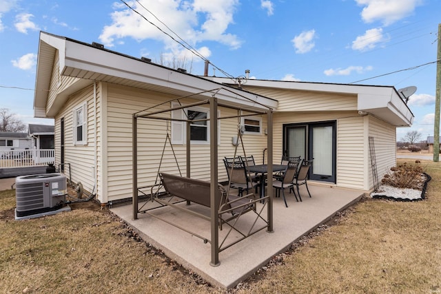 rear view of property with a patio area and central AC unit