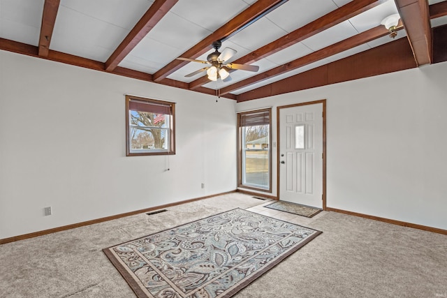 foyer with a ceiling fan, light colored carpet, visible vents, and baseboards