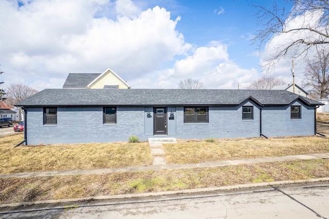 ranch-style house with brick siding and a shingled roof