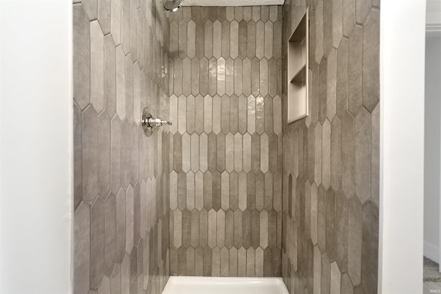 bathroom with a tile shower