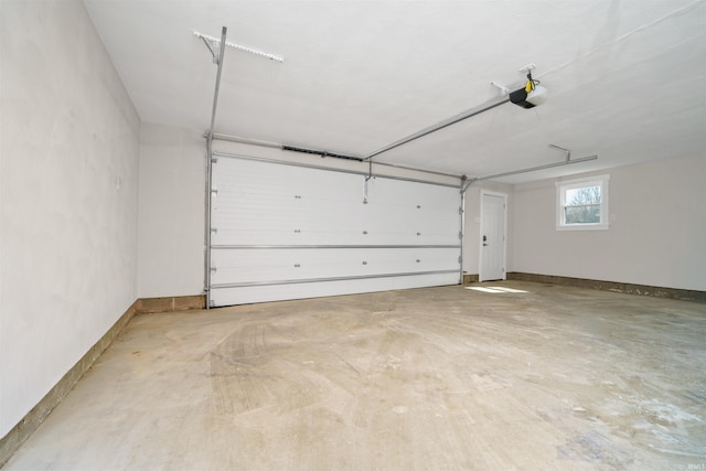 garage featuring a garage door opener and baseboards