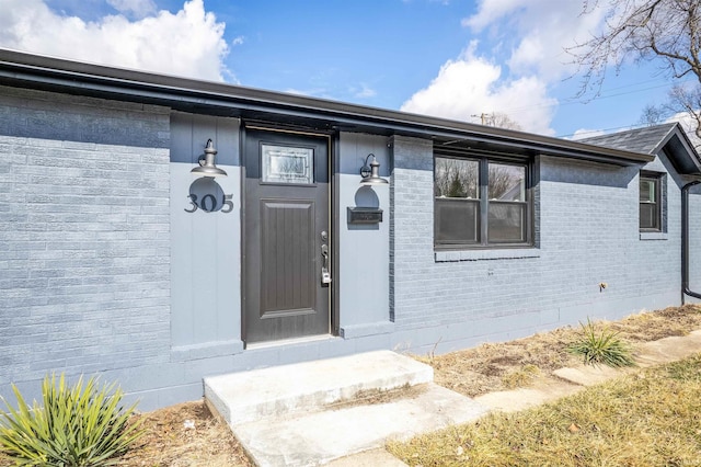 property entrance with brick siding