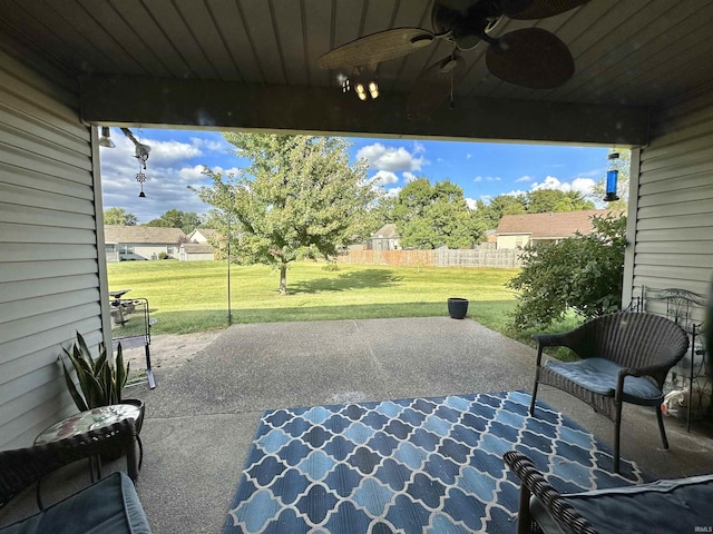 view of patio featuring a ceiling fan and fence