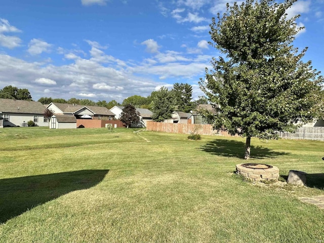 view of yard featuring a fire pit and fence