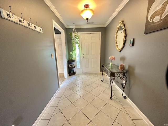 entrance foyer featuring light tile patterned floors, ornamental molding, visible vents, and baseboards