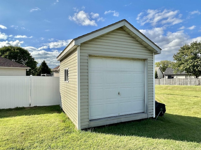 detached garage featuring fence