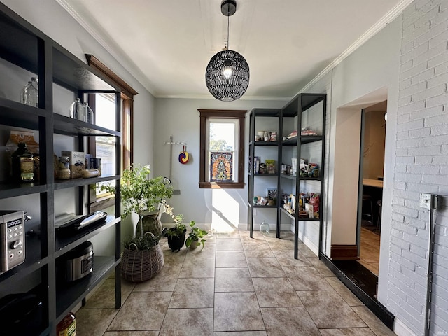 interior space featuring baseboards, crown molding, brick wall, and tile patterned floors