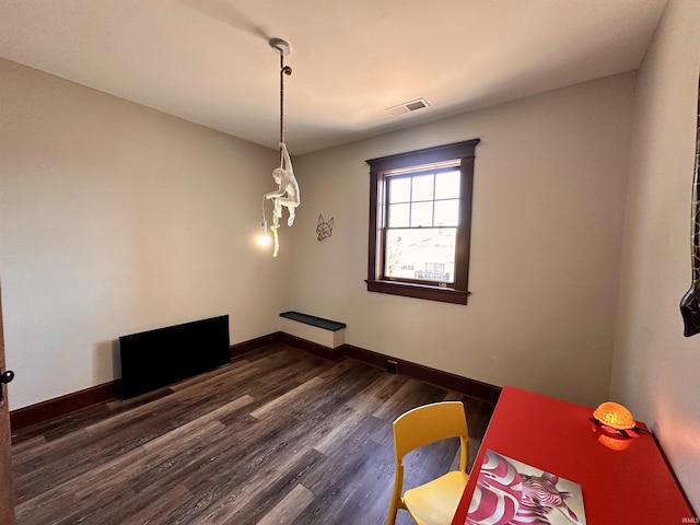 unfurnished dining area featuring visible vents, dark wood finished floors, and baseboards