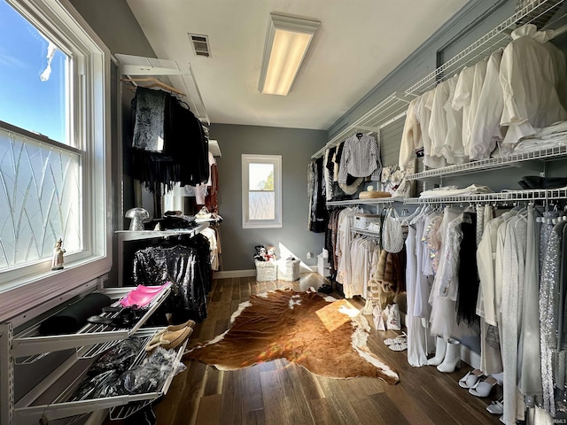 spacious closet featuring visible vents and wood finished floors