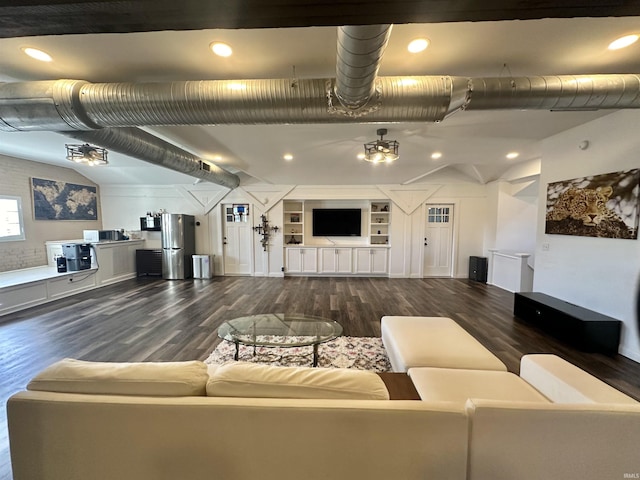 living room with dark wood-style flooring, built in features, and recessed lighting