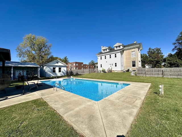 view of swimming pool with a fenced in pool, a fenced backyard, a lawn, and a patio