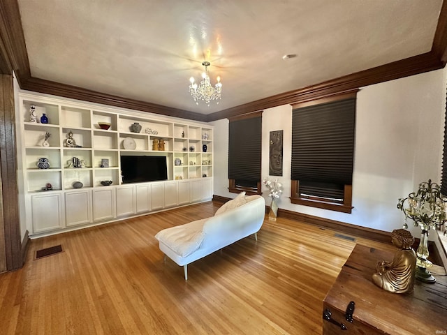 living room featuring a chandelier, visible vents, and wood finished floors