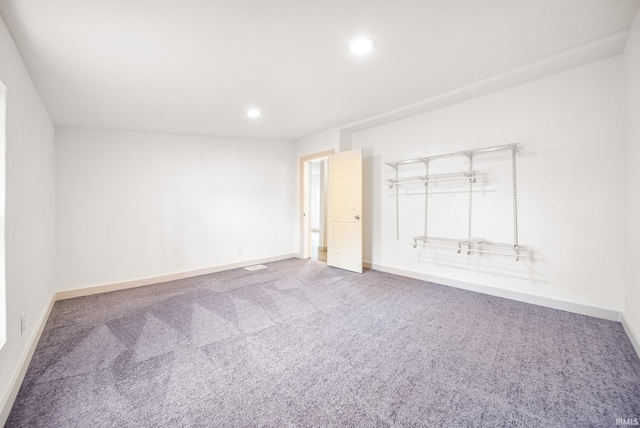 spare room with recessed lighting, carpet, and baseboards