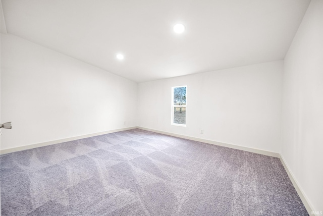 carpeted empty room featuring baseboards and recessed lighting